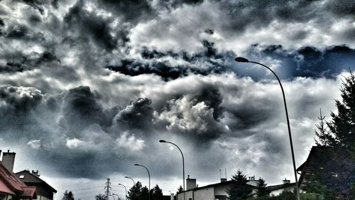 Low angle view of building against cloudy sky