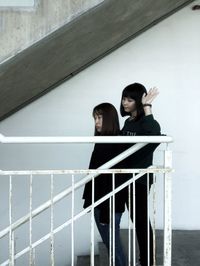 Woman standing against wall