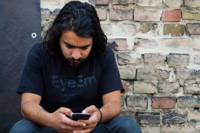Portrait of young woman holding smart phone