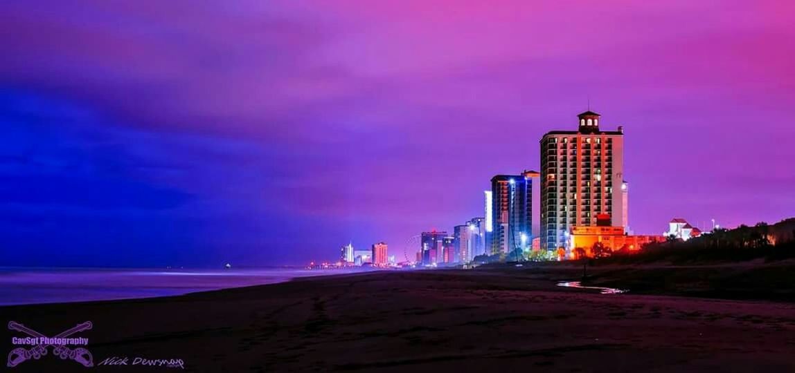 building exterior, architecture, built structure, sky, sunset, beach, city, cloud - sky, dusk, sea, orange color, outdoors, tower, building, silhouette, skyscraper, nature, dramatic sky, scenics, beauty in nature