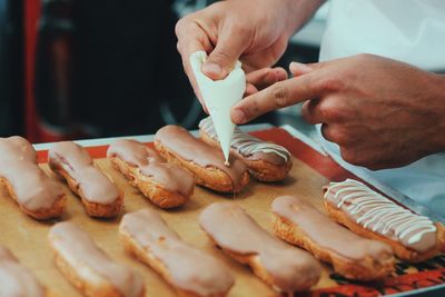 Cropped image of chef icing dessert