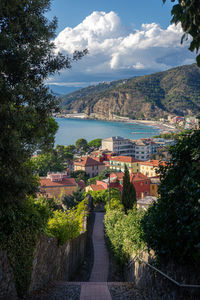 High angle view of townscape by sea against sky