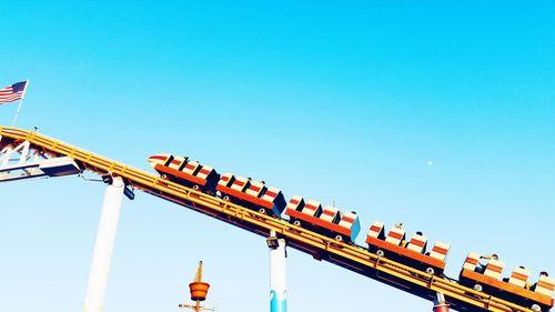 Low angle view of crane against clear blue sky