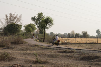 People riding motorcycle on field