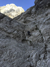 Low angle view of person on rock