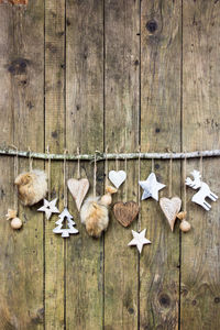 High angle view of christmas decorations hanging on wood