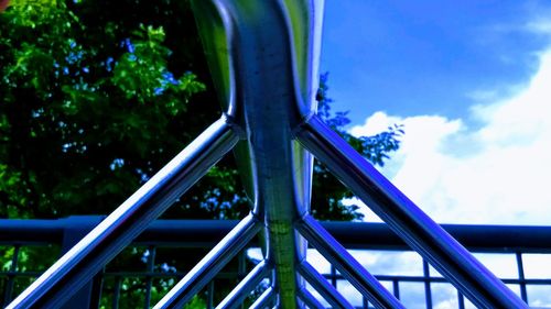 Close-up of playground in park against blue sky