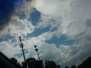 Low angle view of silhouette trees against sky