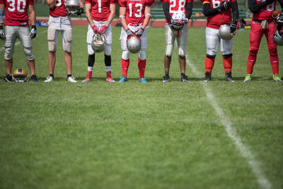 Low section of people standing on field