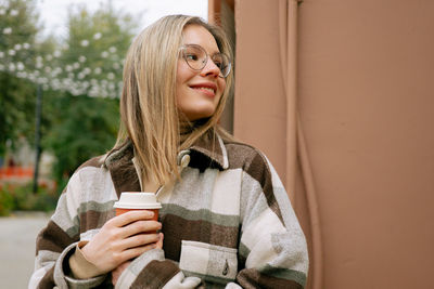 Portrait of woman holding coffee cup