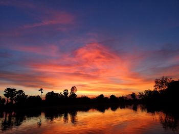 Scenic view of lake against romantic sky at sunset