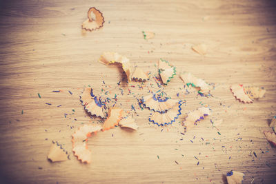 High angle view of pencil shavings on wooden table