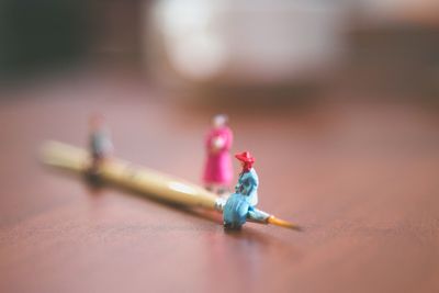 Close-up of figurines and paintbrush on table