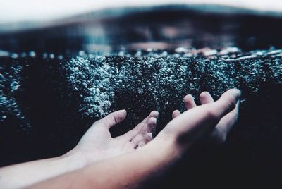 Close-up of hand with water
