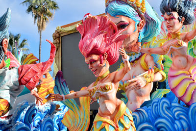 Low angle view of people holding multi colored umbrellas