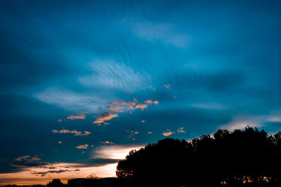 Low angle view of silhouette trees against sky at sunset