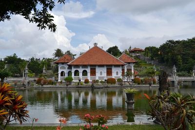 Lake and buildings against sky