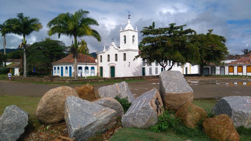 Temple by building against sky