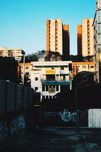 Buildings against clear blue sky in city