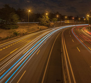 High angle view of light trails on highway at night