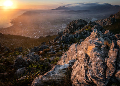 Scenic view of rocky mountains against sky during sunset