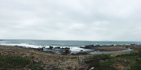 Scenic view of sea against cloudy sky