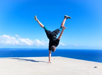 Silhouette of woman jumping on beach