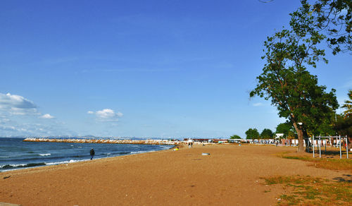 Scenic view of beach against blue sky