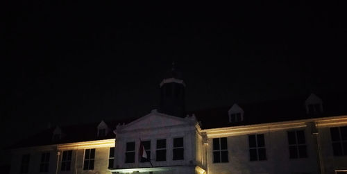 Illuminated buildings against sky at night