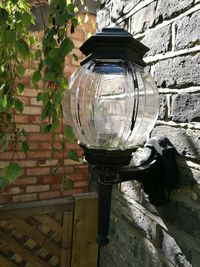 Close-up of lamp against built structure