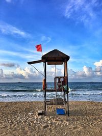 Lifeguard hut on beach against sky