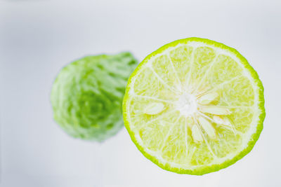 Close-up of lemon slice against white background