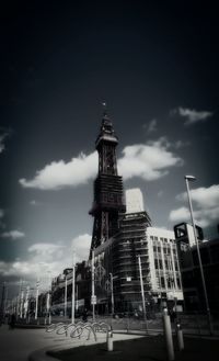 Low angle view of tower against cloudy sky