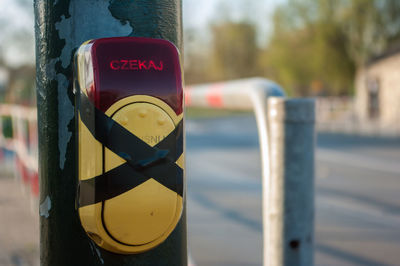 Close-up of sign on wooden pole