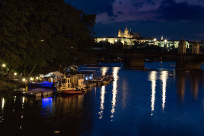 Boats sailing in river at night