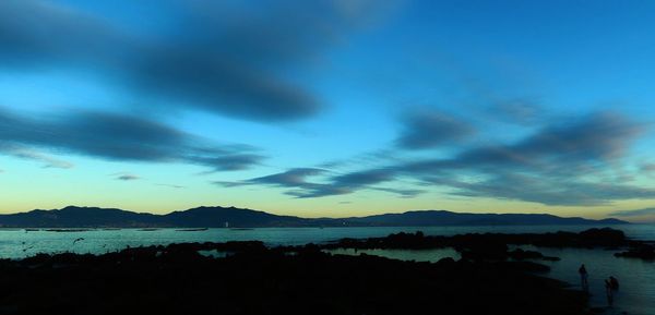 Scenic view of calm sea against cloudy sky