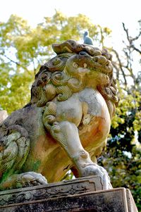 Low angle view of statue against sky