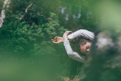 Woman dancing in forest