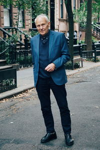 Portrait of senior man standing on road