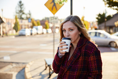 Portrait of young woman holding drink