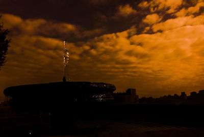 Silhouette of building against dramatic sky