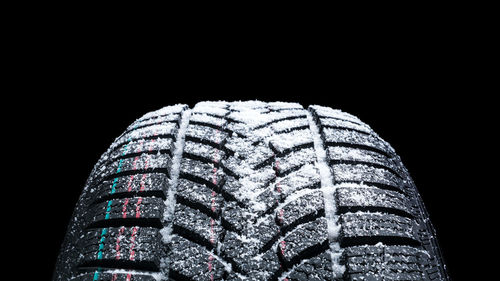 Close-up of tire against black background