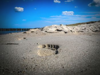 Scenic view of beach against blue sky