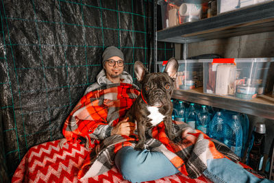 Man and french bulldog in emergency underground shelter