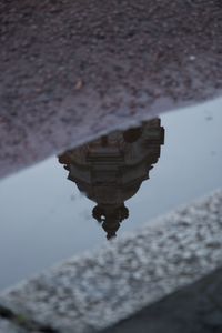 Reflection of building in puddle