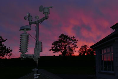 Low angle view of illuminated street light against sky at sunset