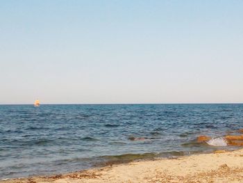 Scenic view of beach against clear sky