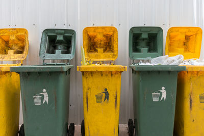 Yellow and green recycle bins