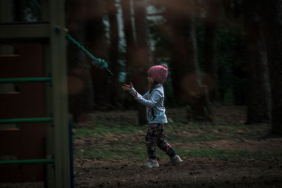 Full length of girl standing by tree