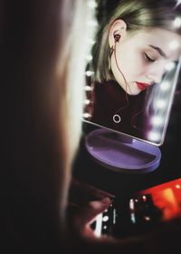 Portrait of young woman holding camera